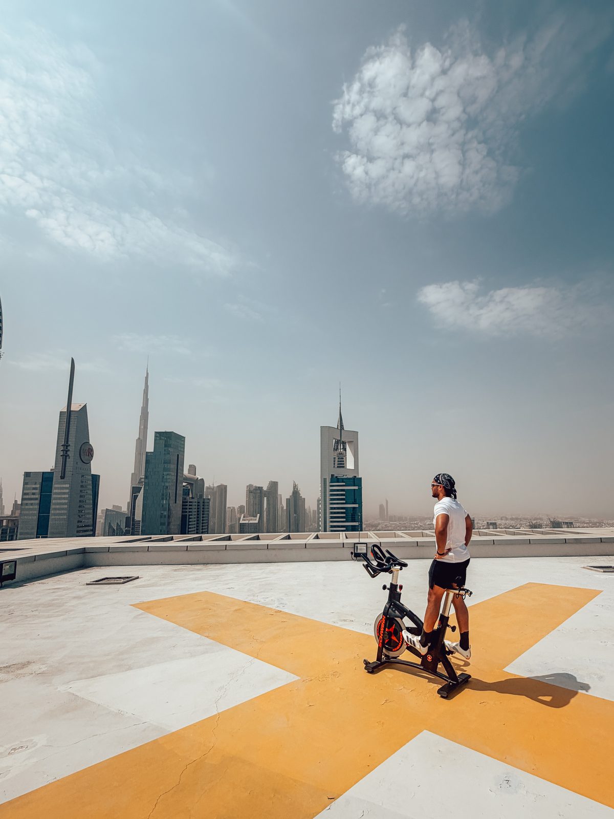A CRANK rider on the Level 43 rooftop helipad above the Dubai skyline on Sheikh Zayed Road
