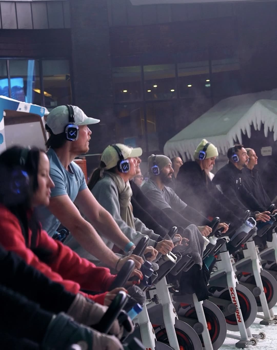 CRANK riders in silent disco headphones on bikes inside Ski Dubai